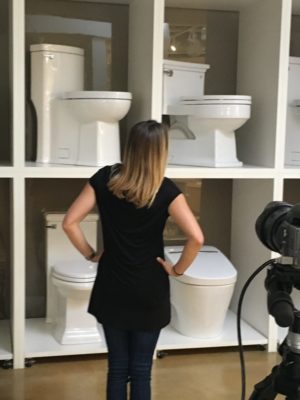 employee from immerse looking at bathroom toilet displays at the showroom in st. louis