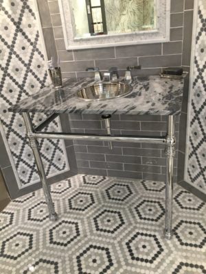 luxury bathroom tile, vanity top, sink, and faucet on display at the immerse showroom in st. louis