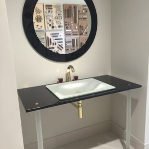luxury bathroom mirror, vanity, sink, and faucet on display at the immerse fixtures showroom