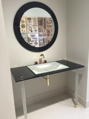 luxury bathroom mirror, vanity, sink, and faucet on display at the immerse fixtures showroom