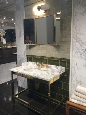 bathroom mirror, faucet, and sink on display at the immerse showroom in st. louis