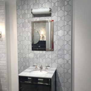 luxury bathroom mirror, sink and faucet on display at the immerse showroom in st. louis