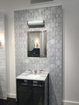 luxury bathroom mirror, sink and faucet on display at the immerse showroom in st. louis