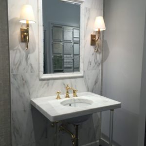 luxury bathroom mirror, faucet, and sink on display at the immerse showroom in st. louis