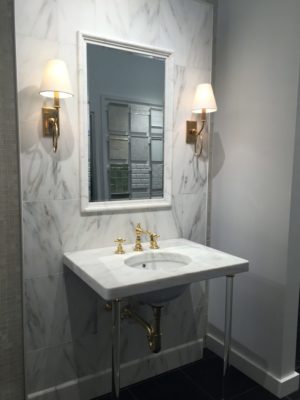 luxury bathroom mirror, faucet, and sink on display at the immerse showroom in st. louis
