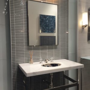 lighted luxury mirror, bathroom faucet and sink on display at the immerse showroom in st. louis