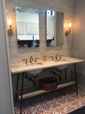 bathroom mirrors, sinks, and faucets on display at the immerse showroom in st. louis