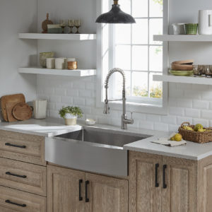 farmhouse kitchen style sink and faucet in designed kitchen space