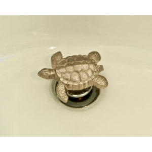 close up of bathroom sink turtle drainplug on display at the immerse showroom in st. louis