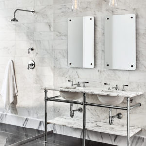 designed bathroom with waterworks faucets, sinks, mirrors, and accessories