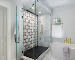 designed bathroom shower and bath tub with fixtures