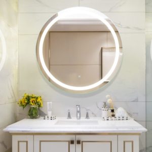 lighted mirror and marble vanity top and sink on display at the immerse showroom in st. louis