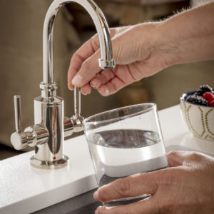 person filling up water from luxury immerse kitchen faucetry