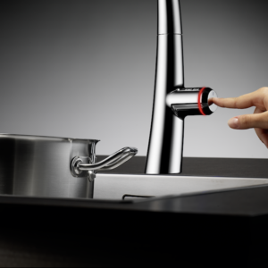 person pressing the side of a kitchen faucet