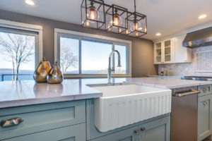 immerse farmhouse sink and faucet in designed kitchen space