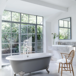 luxury clawfoot bath tub, mirror, and vanity displayed at immerse designer showroom