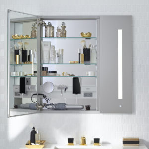 lighted bathroom mirror and accessories on display at immerse