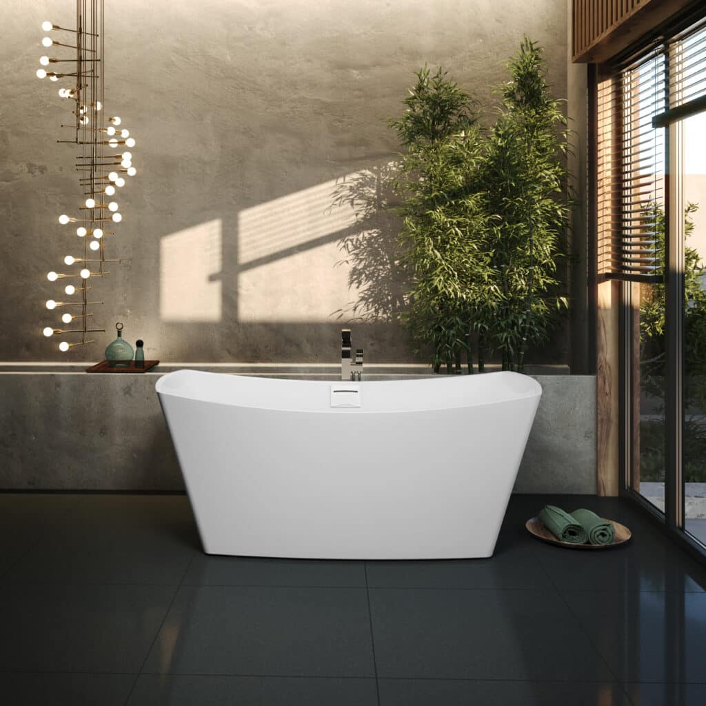 Modern white freestanding bathtub with a deck-mount faucet in a spa-like bathroom with concrete walls and a large window.